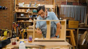 Carpenter making a wall shelf in his shop Instagram 