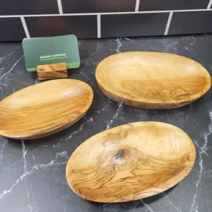 here Three Olive wood bowls various sizes on a black countertop